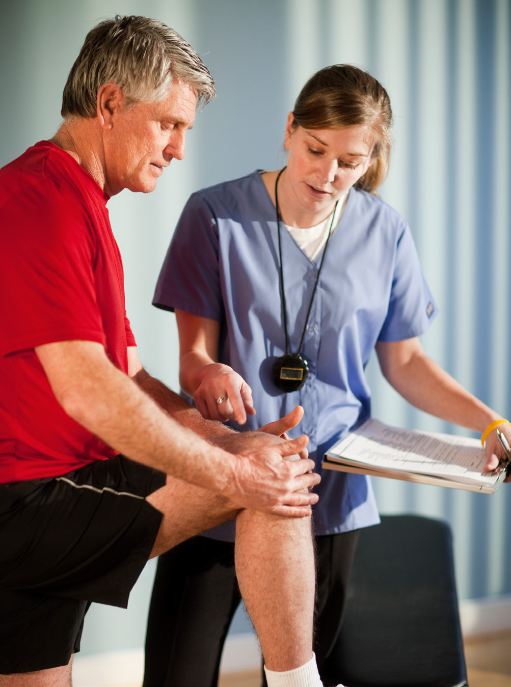 Physical therapist working with knee surgery patient. 